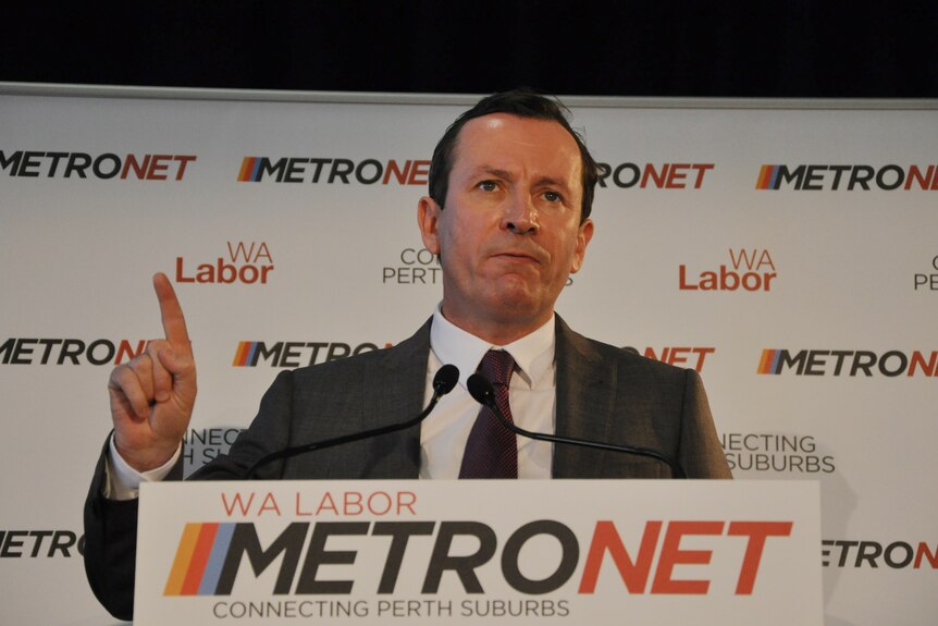 Former WA Premier Mark McGowan stands in front of a Metronet sign in 2015.