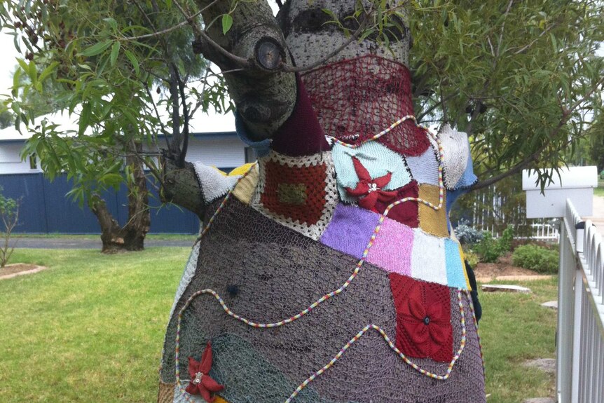 Bottle tree decorated with crochet and knitting