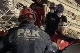 Rescue workers are seen amid rubble in a video still