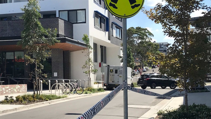 An armaguard van on a suburban street behind police tape