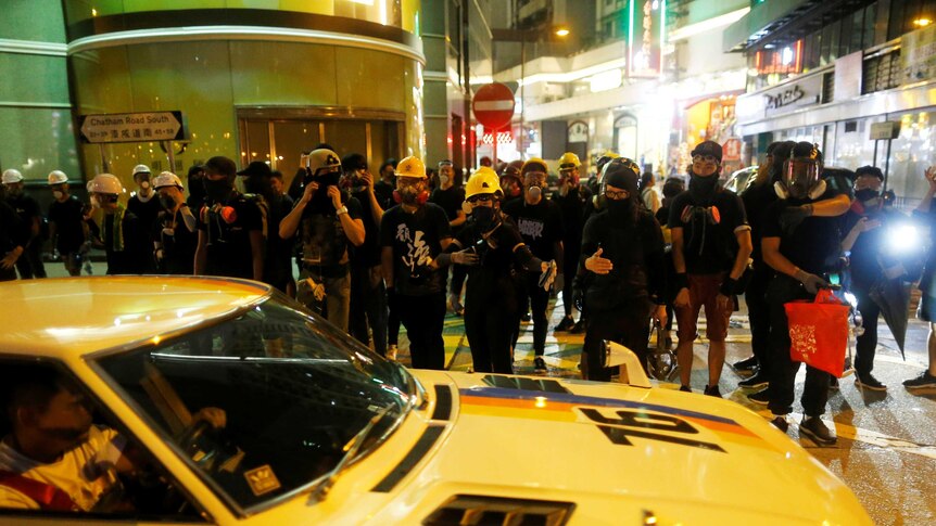 Anti-extradition bill protesters walk through Tsim Sha Tsui neighbourhood in Hong Kong.