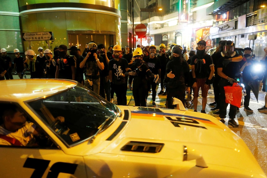 Anti-extradition bill protesters walk through Tsim Sha Tsui neighbourhood in Hong Kong.