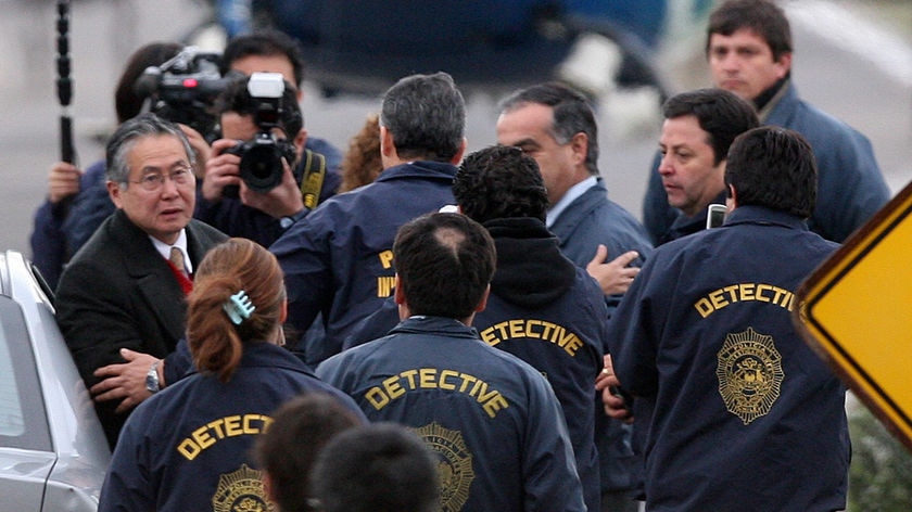 Former Peruvian President Alberto Fujimori (far left) has arrived in Peru to face charges of abusing human rights and stealing public money (File Photo).