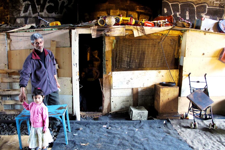 Logor outside the shack he built for his wife and six children under the railway bridge at Porte de la Chappelle