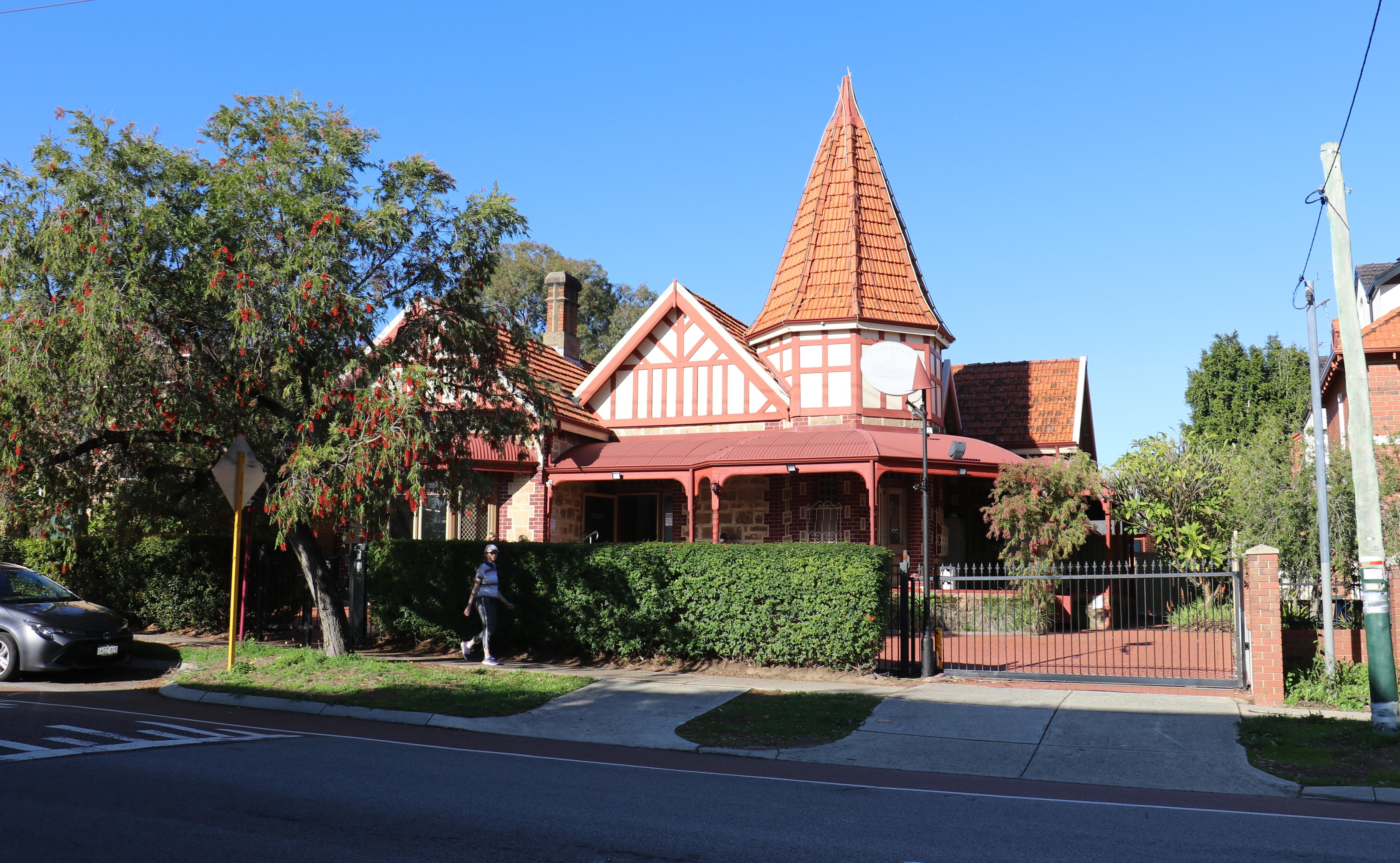The exterior of a beautiful, old house in Northbridge, surrounded by trees.