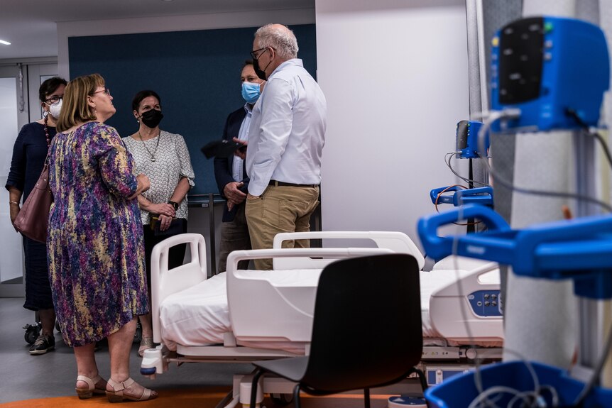 El primer ministro visita una cama de hospital vacía que se utiliza para capacitar a estudiantes de medicina.   