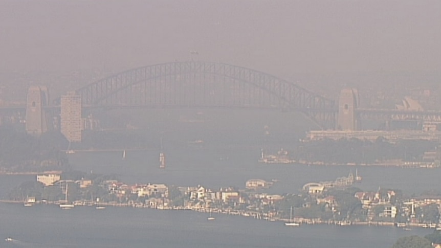 A large curved bridge, surrounded by smoke.