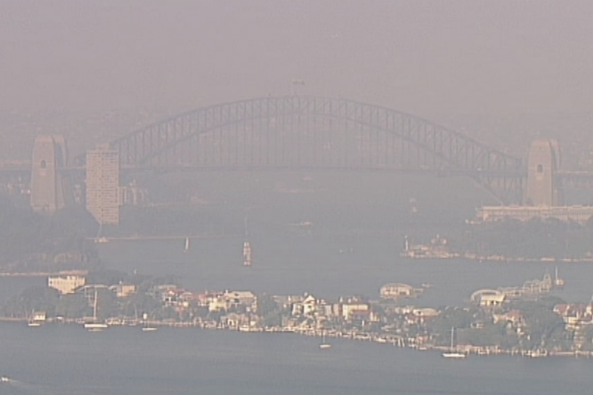 A large curved bridge, surrounded by smoke.