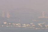 A large curved bridge, surrounded by smoke.