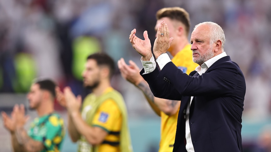 Australian coach Graham Arnold applauds fans after the Socceroos lose a match at the World Cup.