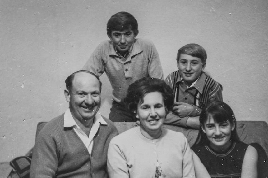 A black and white photo of a family, a mum and dad with their two sons and one daughter.