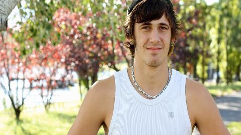 Teenager boy stands in park