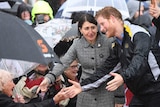 Harry and Gladys shaking hands in the rain.