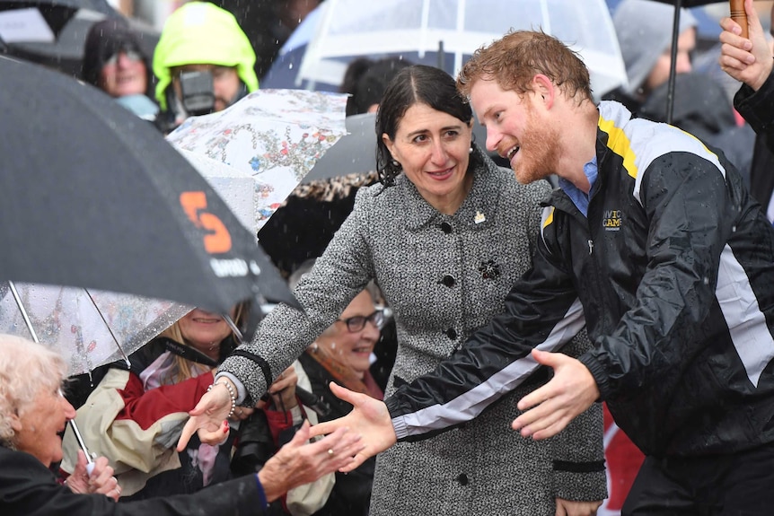 Harry and Gladys shaking hands in the rain.