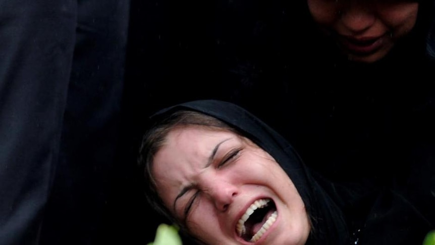 A mourner at the funeral of one of the Christmas Island boat disaster victims grieves