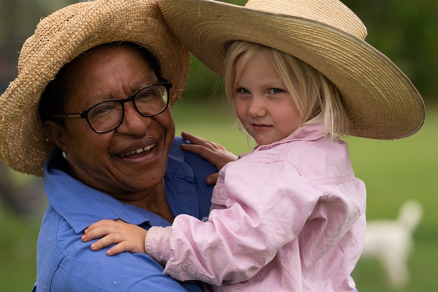 Photo of a woman holding a child.