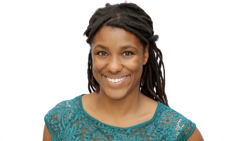 Close up photo of Tanya Latty looking directly at camera, against a plain white background.