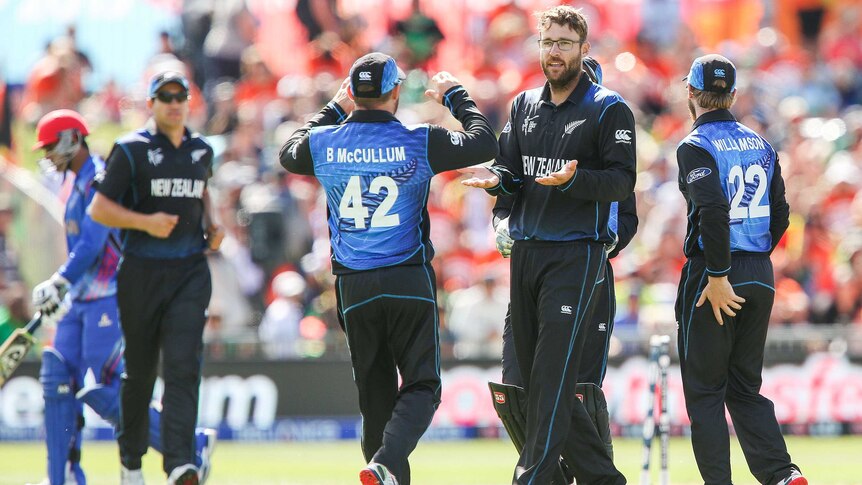 Newealand's Daniel Vettori is congratulated by Brendon McCullum after taking a wicket against Afghanistan.