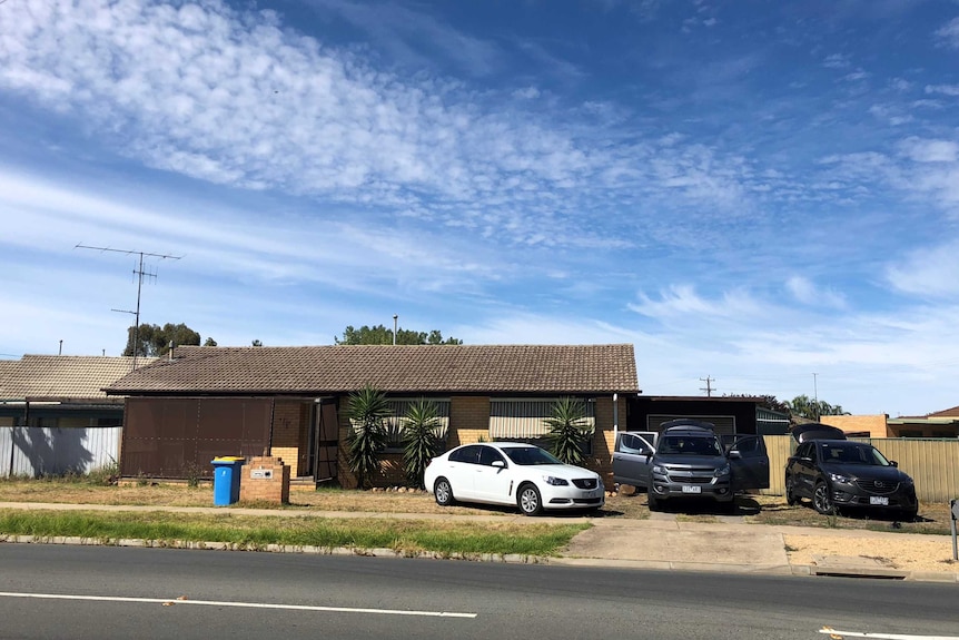 Three cars are seen parked in the driveway of a brick house in Shepparton.