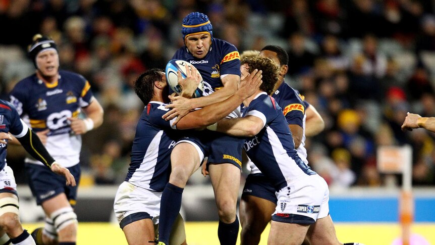 Busting through ... Matt Giteau makes a hit-up in his last game in Canberra for the Brumbies.