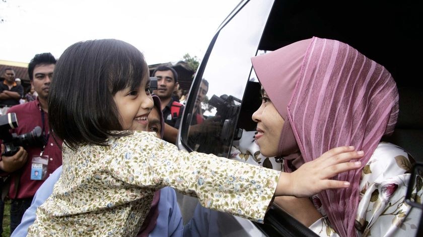 Muslim model Kartika Sari Dewi Shukarno is greeted by her five-year-old daughter