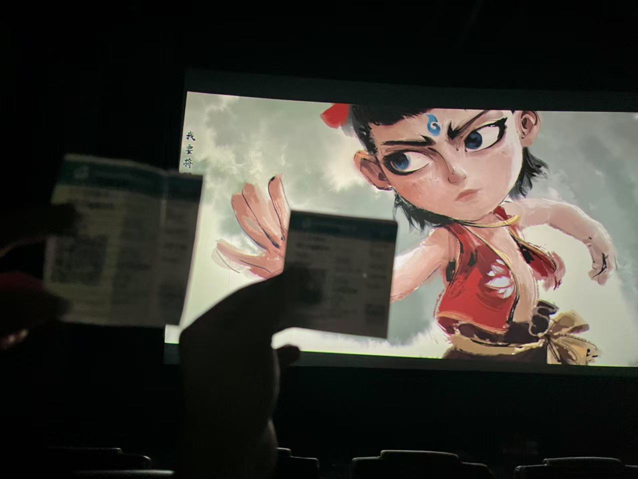 A picture of an anime character on a movie screen.