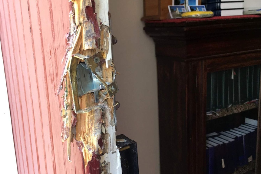 A door damaged by thieves at Windermere church