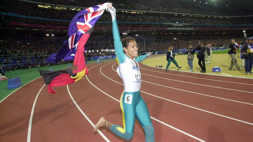 Cathy Freeman holding flags after 2000 Olympic win.