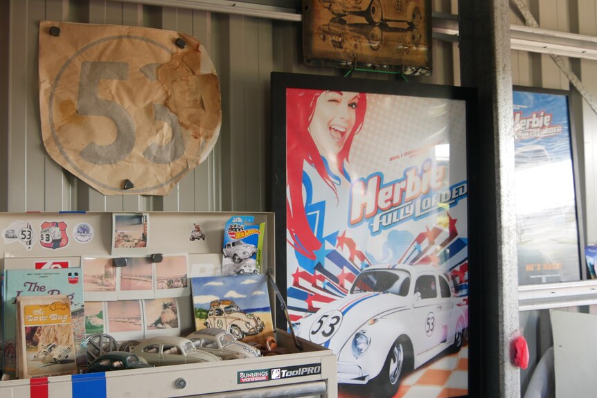 Herbie car memorabilia on the wall of a garage.