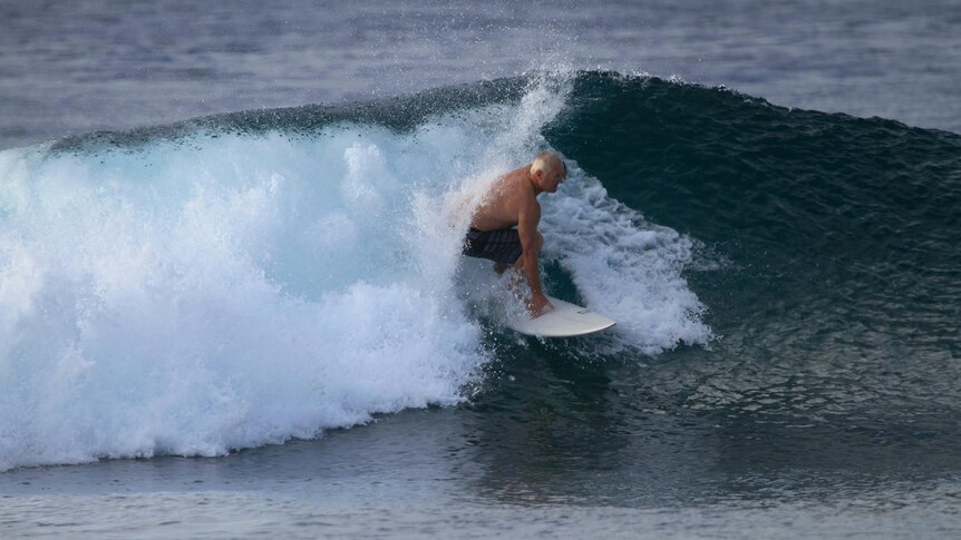 A man surfing inside a tube on a surfboard