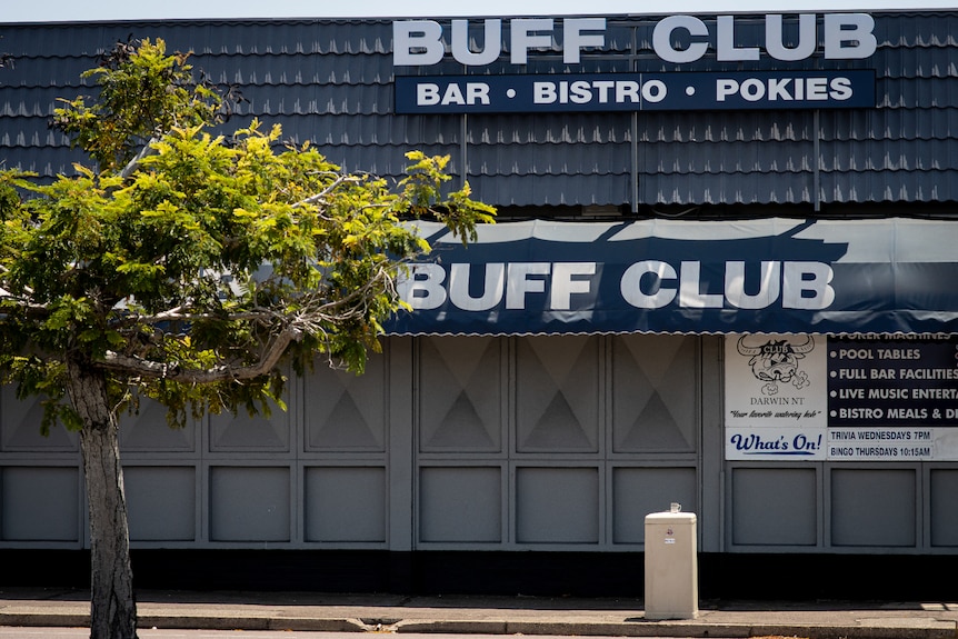 The front of a pub with navy blue awnings and featuring a large sign reading 'Buff Club'.