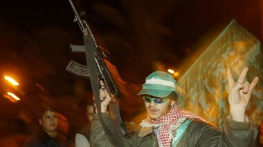 A member of the Hamas military wing parades in Gaza City.