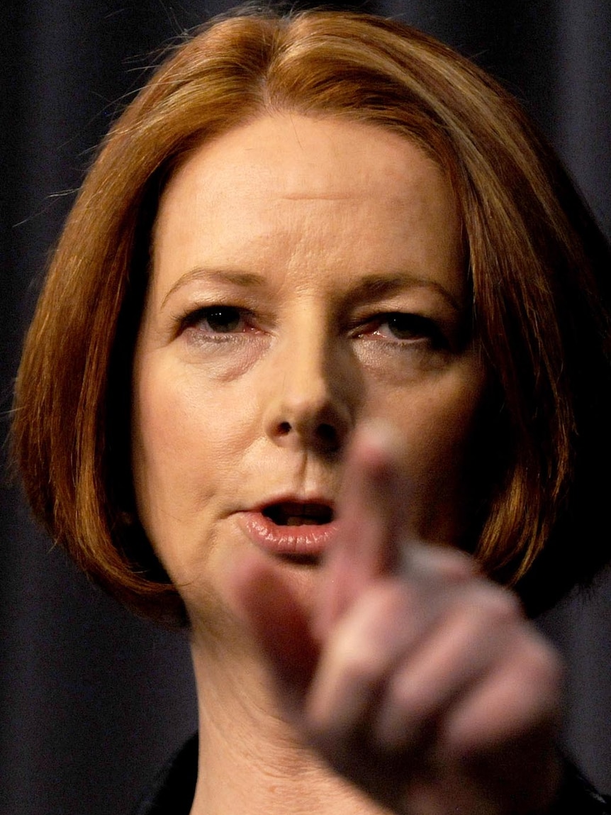 Julia Gillard points during a press conference in Canberra on October 13, 2011.