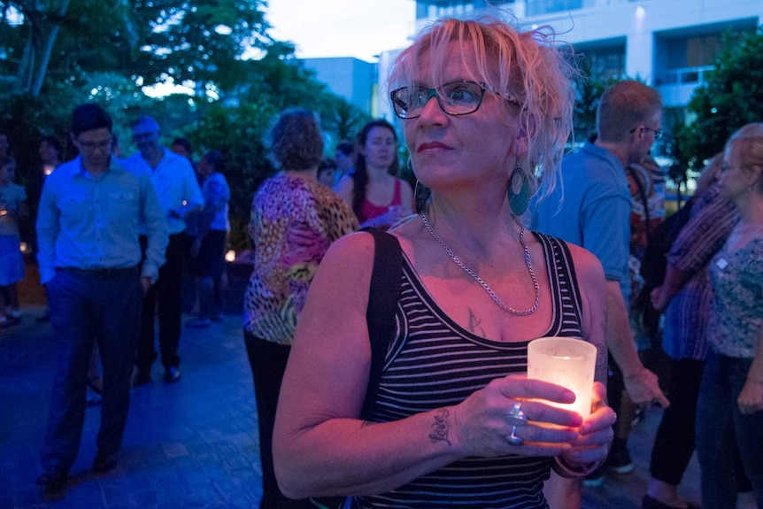 Ange Sheedy holds a candle in memory of her sister.