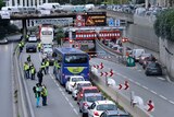 Cars are banked up as demonstrators in hi-vis yellow vests block a motorway exit to protest fuel taxes in Marseille.