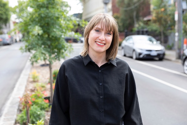 A portrait photo of Rachel Busbridge standing on a street