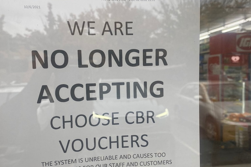 A sign posted to a window warns customers ChooseCBR vouchers will not be accepted.