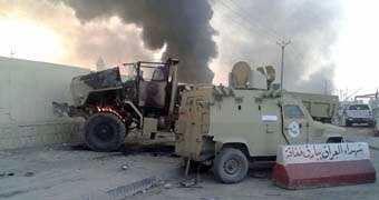 CUSTOM IMAGE of burning Iraqi security vehicles