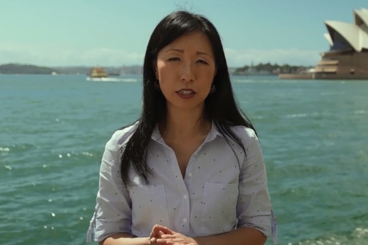 Justine Toh stands in front of the Opera House in a still from For The Love of God