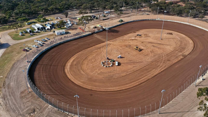 A photo taken from a drone of a dirt racetrack.