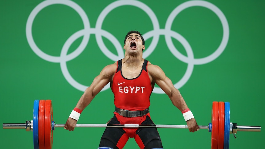 Mohamed Mahmoud of Egypt lifts during the Men's 77kg Group A weightlifting contest in Rio.