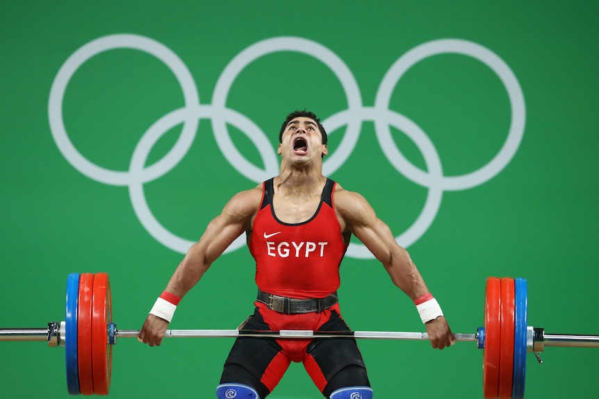 Mohamed Mahmoud of Egypt lifts during the Men's 77kg Group A weightlifting contest in Rio.