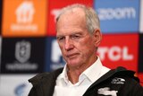 Wayne Bennett sits with a neutral expression on his face