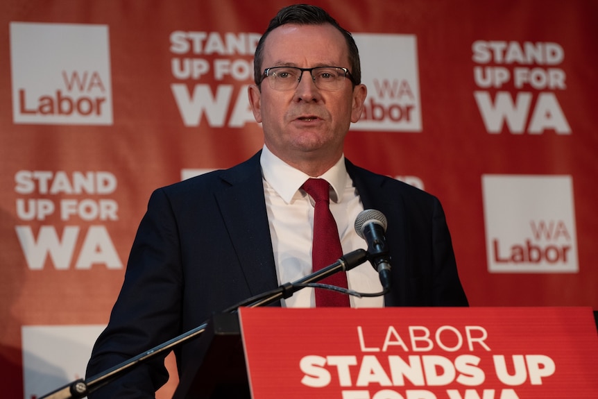 A mid shot of Mark McGowan standing at a lectern in front of WA Labor party signage.