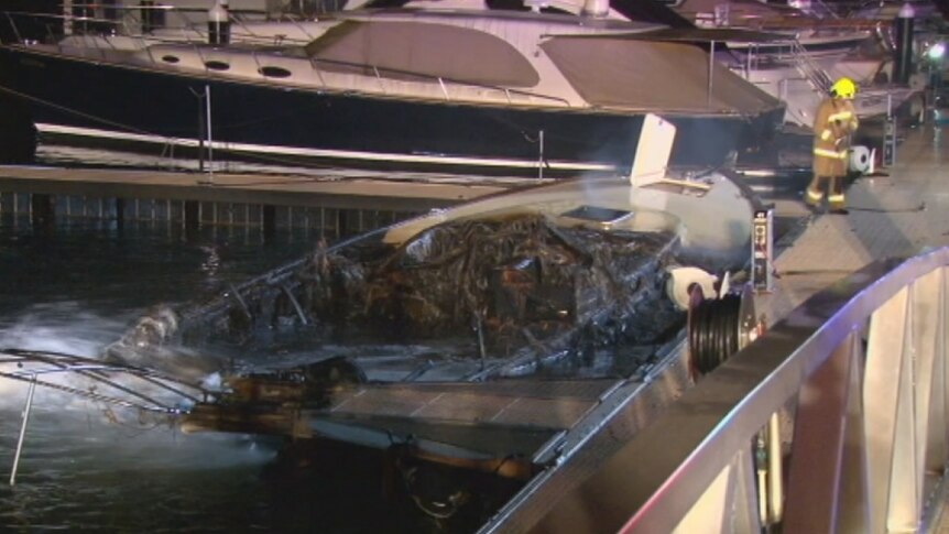The charred remains of a luxury boat in Woolloomooloo