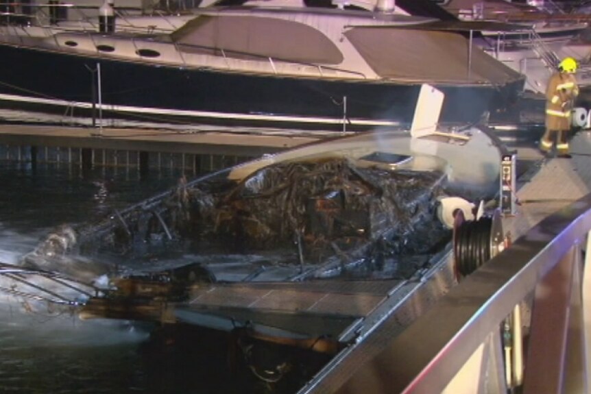 The charred remains of a luxury boat in Woolloomooloo
