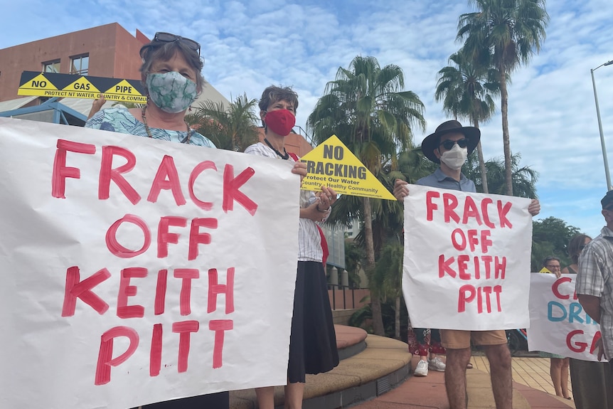 People holding hand-painted signs reading 'frack of Keith'