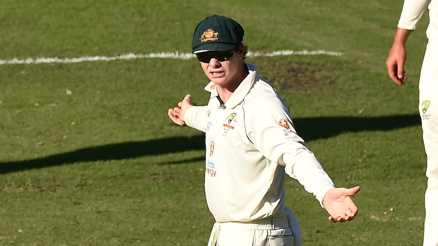Steve Smith shrugs towards Tim Paine, while standing in the field Nathan Lyon Pat Cummins during a Test against India.