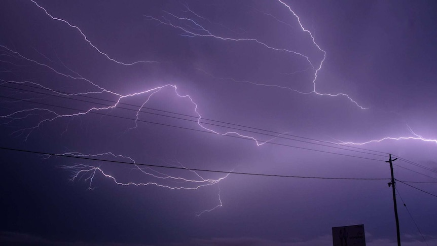 Lighting strikes with cars going past.