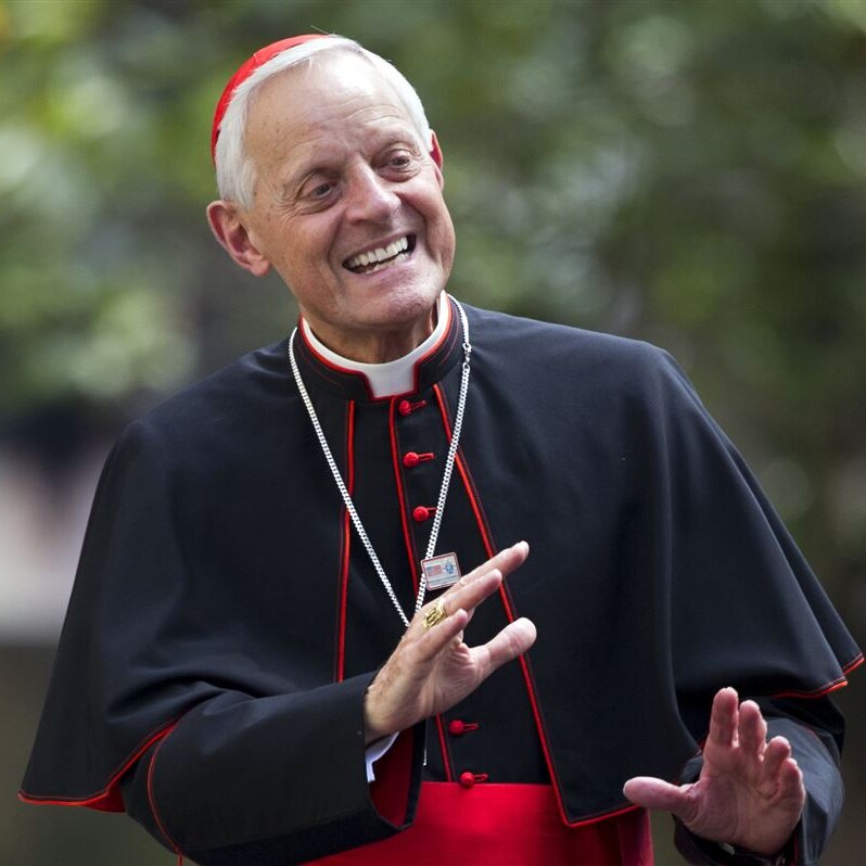 Cardinal Wuerl, Archbishop of Washington, in his red skullcap, laughing and leaning back.
